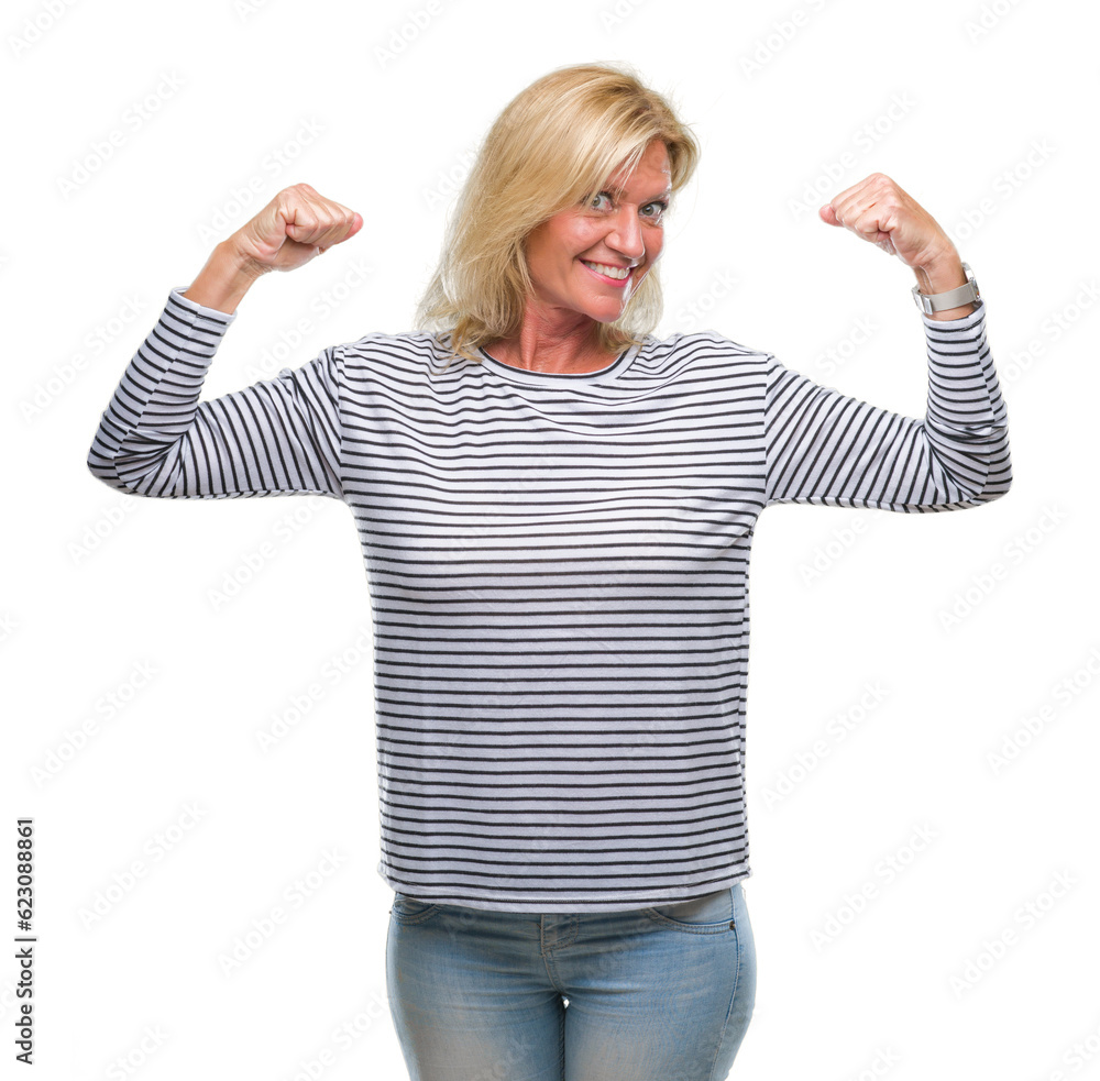 Middle age blonde woman over isolated background showing arms muscles smiling proud. Fitness concept. Middle age blonde woman over isolated background showing arms muscles smiling proud. Fitness concept.
