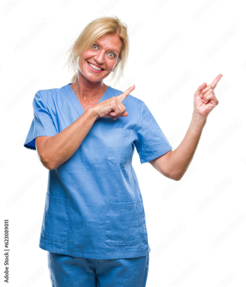 Obraz premium Middle age blonde woman wearing doctor nurse uniform over isolated background smiling and looking at the camera pointing with two hands and fingers to the side.