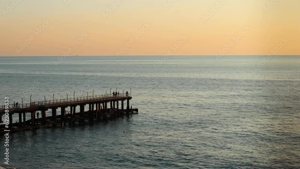Orange sky sunset on the beach with old jetty silhouette Orange sky sunset on the beach with old jetty silhouette