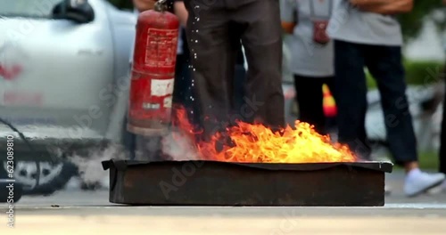 fireman Firefighters spraying water onto a burning pit Rescue trained in fire fighting extinguisher hazardous fires