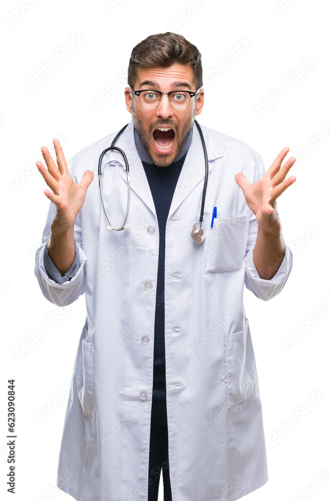 Young handsome doctor man over isolated background celebrating crazy and amazed for success with arms raised and open eyes screaming excited. Winner concept Young handsome doctor man over isolated background celebrating crazy and amazed for success with arms raised and open eyes screaming excited. Winner concept