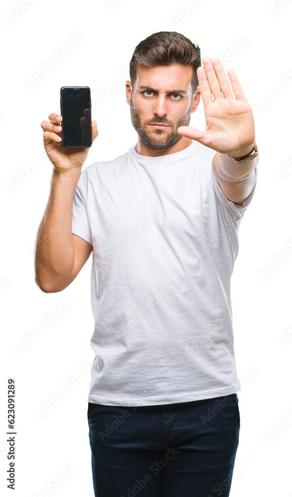 Young handsome man showing smartphone screen over isolated background with open hand doing stop sign with serious and confident expression, defense gesture Young handsome man showing smartphone screen over isolated background with open hand doing stop sign with serious and confident expression, defense gesture