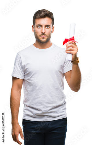 Young handsome man holding degree over isolated background with a confident expression on smart face thinking serious