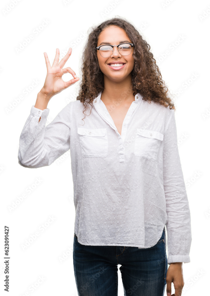Beautiful young hispanic woman smiling positive doing ok sign with hand and fingers. Successful expression. Beautiful young hispanic woman smiling positive doing ok sign with hand and fingers. Successful expression.
