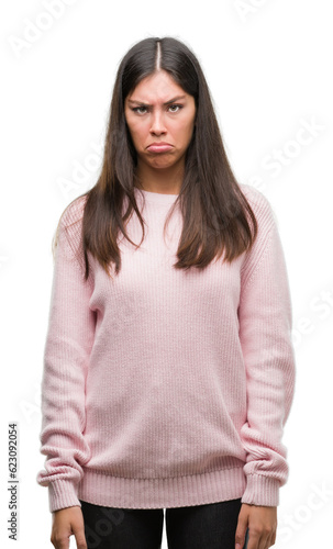 Young beautiful hispanic woman wearing a sweater depressed and worry for distress, crying angry and afraid. Sad expression.