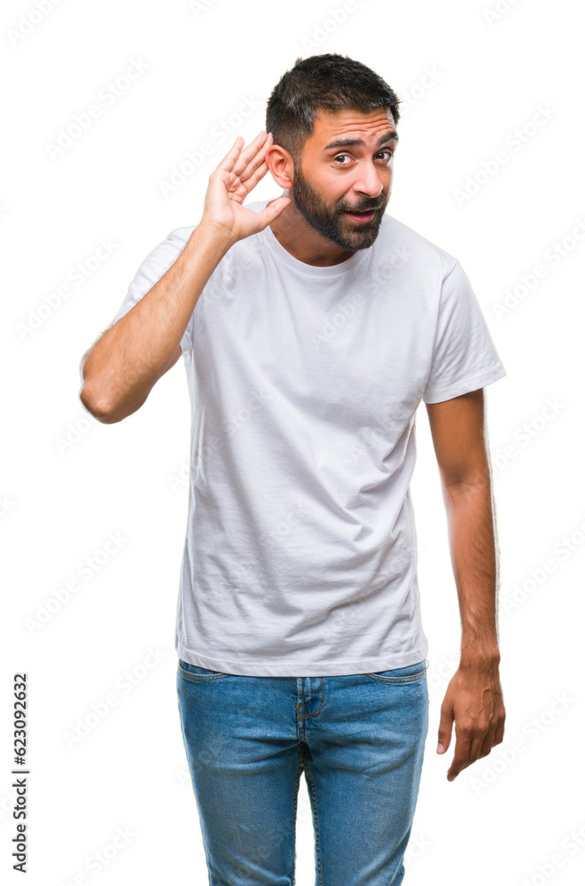 Adult hispanic man over isolated background smiling with hand over ear listening an hearing to rumor or gossip. Deafness concept. Adult hispanic man over isolated background smiling with hand over ear listening an hearing to rumor or gossip. Deafness concept.