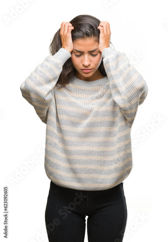 Fotografie Young beautiful arab woman wearing winter sweater over isolated background suffering from headache desperate and stressed because pain and migraine