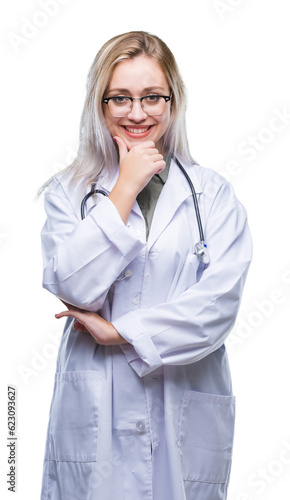 Young blonde doctor woman over isolated background looking confident at the camera with smile with crossed arms and hand raised on chin. Thinking positive.