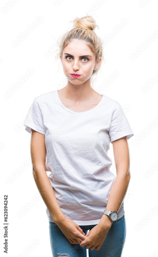 Fototapeta premium Young beautiful blonde woman wearing white t-shirt over isolated background making fish face with lips, crazy and comical gesture. Funny expression.