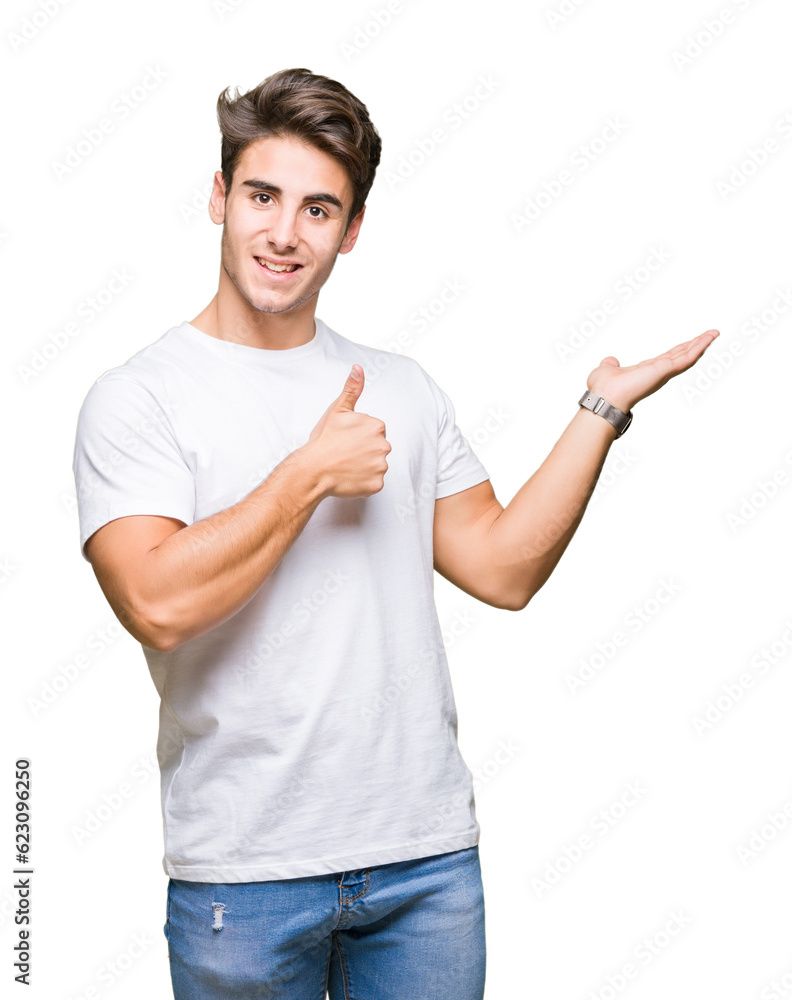 Young handsome man wearing white t-shirt over isolated background Showing palm hand and doing ok gesture with thumbs up, smiling happy and cheerful Young handsome man wearing white t-shirt over isolated background Showing palm hand and doing ok gesture with thumbs up, smiling happy and cheerful
