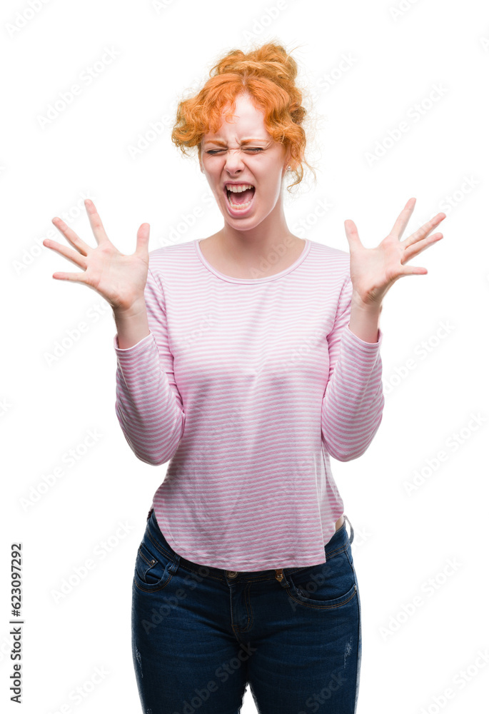 Young redhead woman celebrating mad and crazy for success with arms raised and closed eyes screaming excited. Winner concept Young redhead woman celebrating mad and crazy for success with arms raised and closed eyes screaming excited. Winner concept