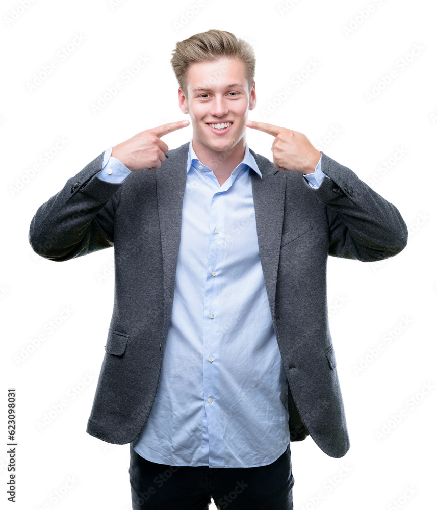 Young handsome blond business man smiling confident showing and pointing with fingers teeth and mouth. Health concept. Young handsome blond business man smiling confident showing and pointing with fingers teeth and mouth. Health concept.