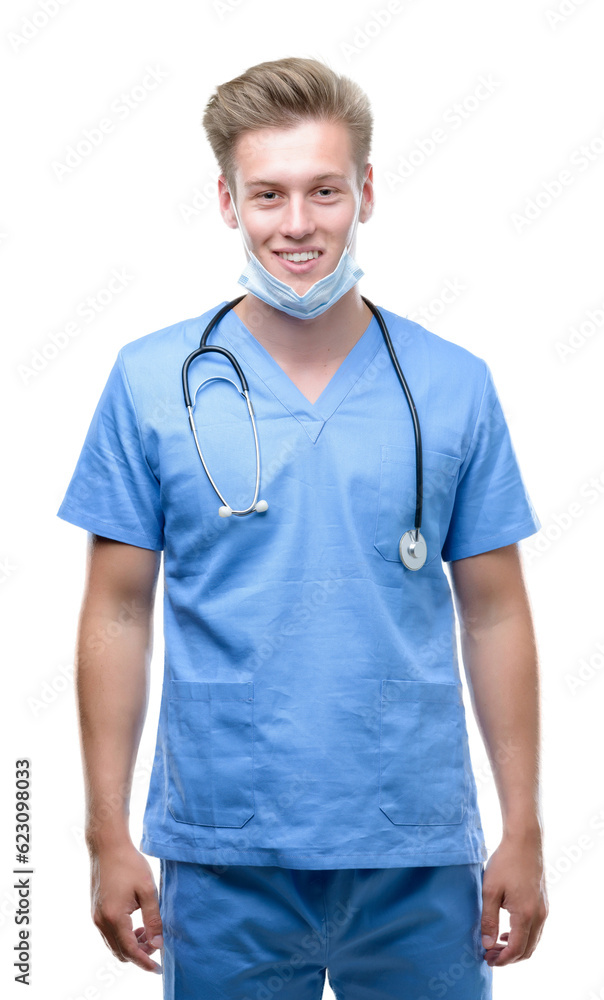 Young handsome blond doctor with a happy face standing and smiling with a confident smile showing teeth Young handsome blond doctor with a happy face standing and smiling with a confident smile showing teeth