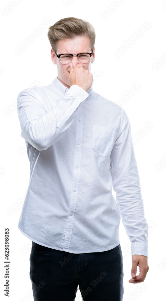 Young handsome blond man smelling something stinky and disgusting, intolerable smell, holding breath with fingers on nose. Bad smells concept. Young handsome blond man smelling something stinky and disgusting, intolerable smell, holding breath with fingers on nose. Bad smells concept.