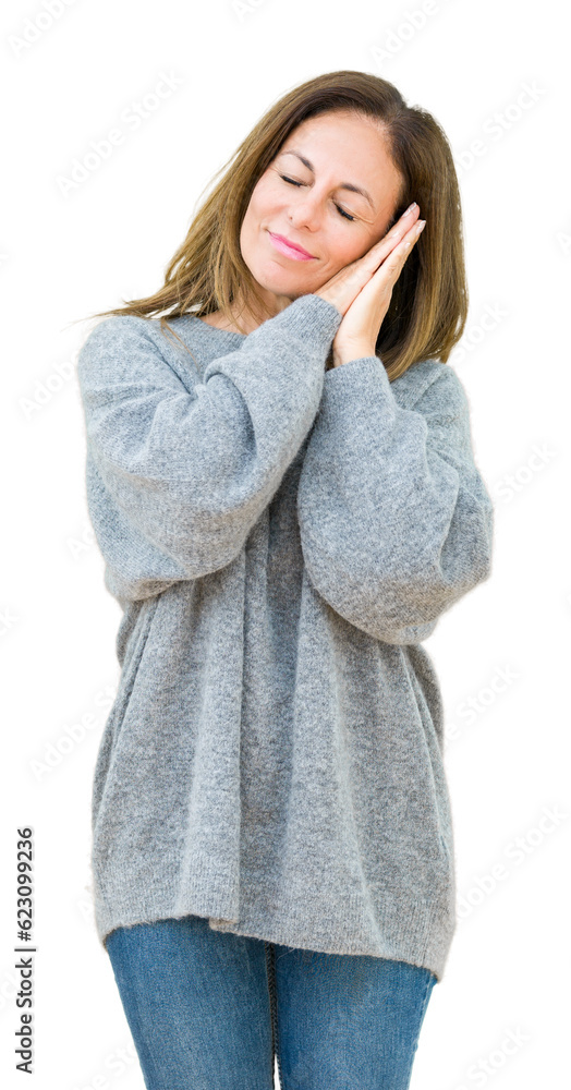 Beautiful middle age woman wearing winter sweater over isolated background sleeping tired dreaming and posing with hands together while smiling with closed eyes.