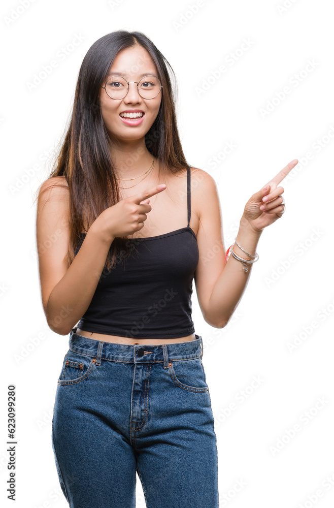 Young asian woman wearing glasses over isolated background smiling and looking at the camera pointing with two hands and fingers to the side. Young asian woman wearing glasses over isolated background smiling and looking at the camera pointing with two hands and fingers to the side.