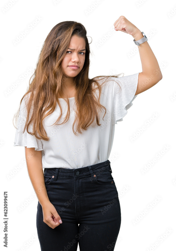 Obraz premium Young beautiful brunette business woman over isolated background Strong person showing arm muscle, confident and proud of power