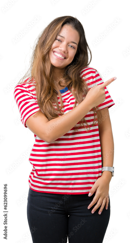 Young beautiful brunette woman wearing stripes t-shirt over isolated background cheerful with a smile of face pointing with hand and finger up to the side with happy and natural expression on face Young beautiful brunette woman wearing stripes t-shirt over isolated background cheerful with a smile of face pointing with hand and finger up to the side with happy and natural expression on face