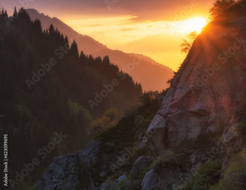 Golden sunset and sun in mountains with forest. Beautiful mountain landscape © Lana Kray
