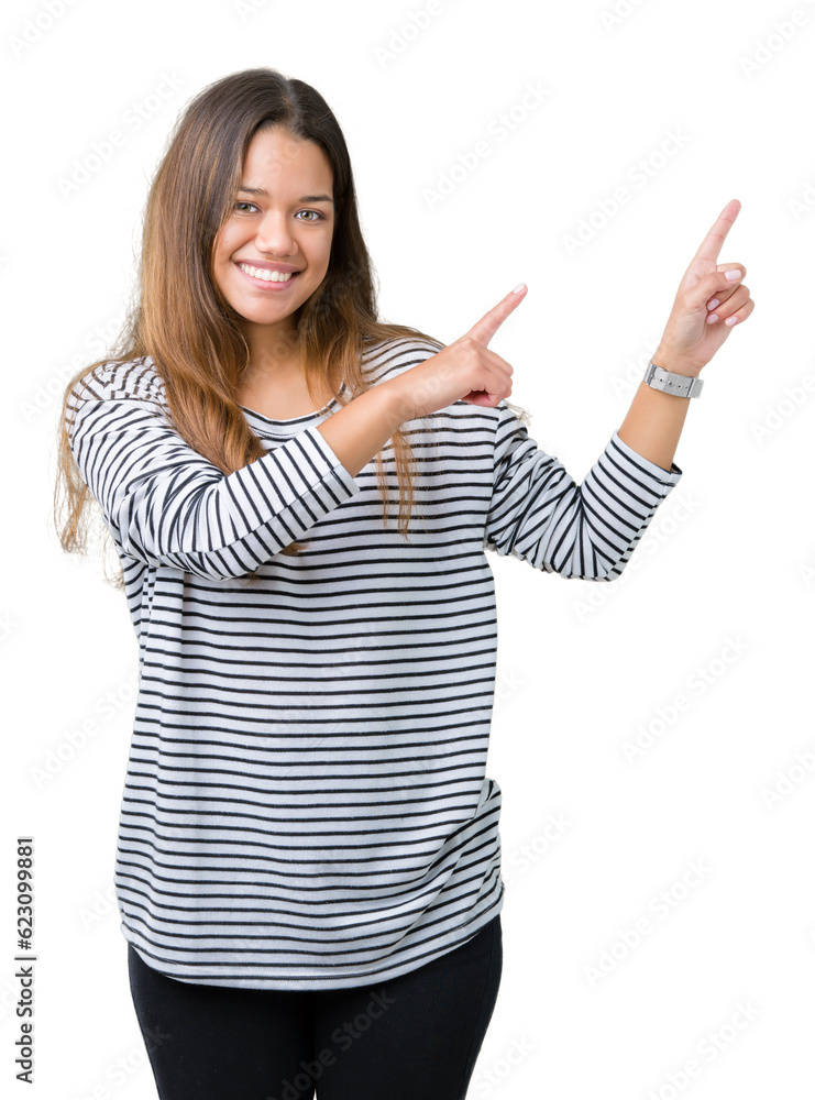 Young beautiful brunette woman wearing stripes sweater over isolated background smiling and looking at the camera pointing with two hands and fingers to the side. Young beautiful brunette woman wearing stripes sweater over isolated background smiling and looking at the camera pointing with two hands and fingers to the side.