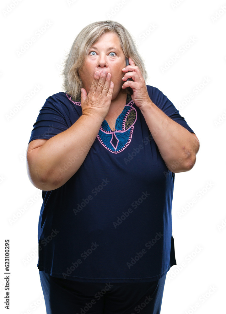 Senior plus size caucasian woman talking on the phone over isolated background cover mouth with hand shocked with shame for mistake, expression of fear, scared in silence, secret concept Senior plus size caucasian woman talking on the phone over isolated background cover mouth with hand shocked with shame for mistake, expression of fear, scared in silence, secret concept