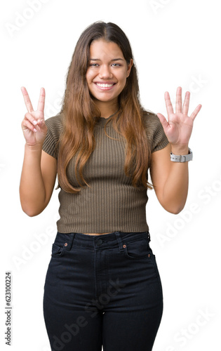 Young beautiful brunette woman over isolated background showing and pointing up with fingers number seven while smiling confident and happy.