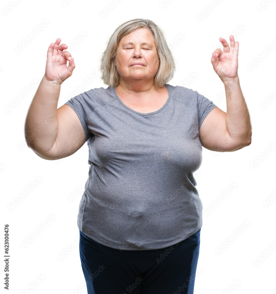 Senior plus size caucasian woman over isolated background relax and smiling with eyes closed doing meditation gesture with fingers. Yoga concept. Senior plus size caucasian woman over isolated background relax and smiling with eyes closed doing meditation gesture with fingers. Yoga concept.