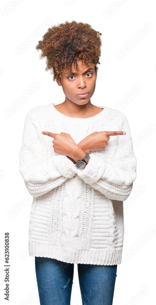 Beautiful young african american woman wearing winter sweater over isolated background Pointing to both sides with fingers, different direction disagree Beautiful young african american woman wearing winter sweater over isolated background Pointing to both sides with fingers, different direction disagree