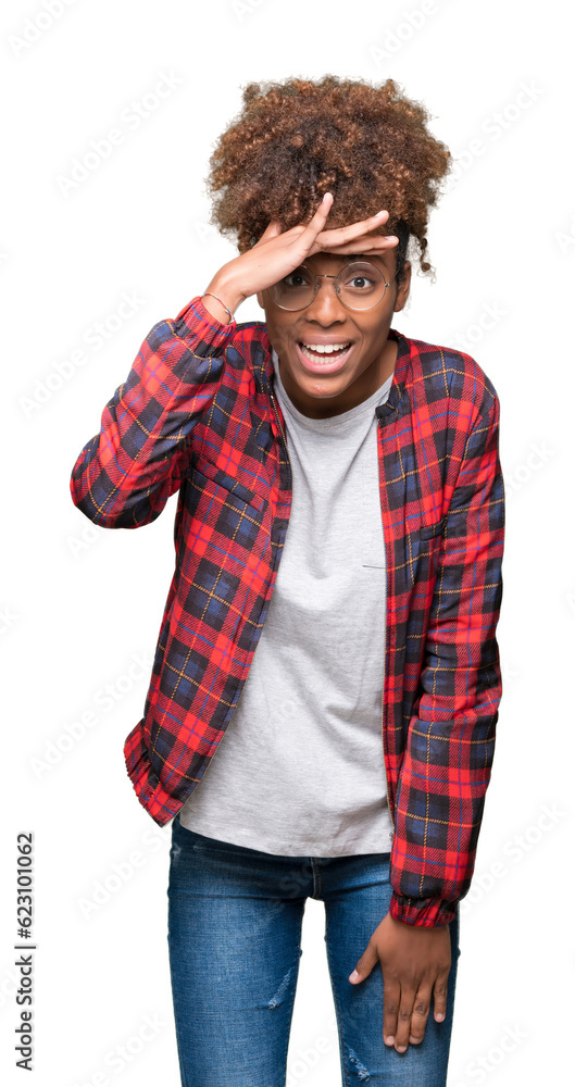 Beautiful young african american woman wearing glasses over isolated background very happy and smiling looking far away with hand over head. Searching concept. Beautiful young african american woman wearing glasses over isolated background very happy and smiling looking far away with hand over head. Searching concept.