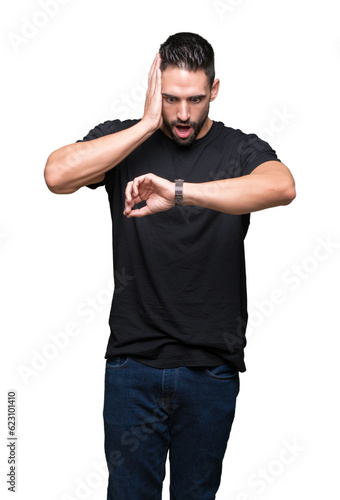 Young handsome man over isolated background Looking at the watch time worried, afraid of getting late