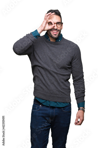 Young handsome man wearing glasses over isolated background doing ok gesture with hand smiling, eye looking through fingers with happy face.