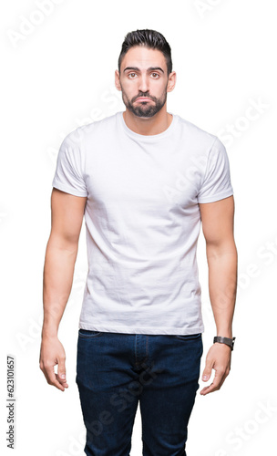 Young man wearing casual white t-shirt over isolated background depressed and worry for distress, crying angry and afraid. Sad expression.