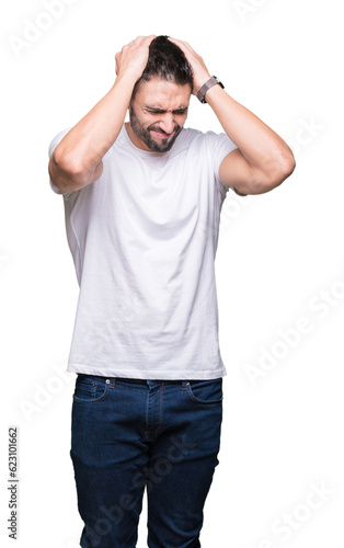 Young man wearing casual white t-shirt over isolated background suffering from headache desperate and stressed because pain and migraine. Hands on head.
