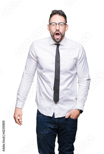 Young handsome business man wearing glasses over isolated background In shock face, looking skeptical and sarcastic, surprised with open mouth