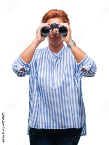 Senior caucasian woman looking through binoculars over isolated background with a confident expression on smart face thinking serious