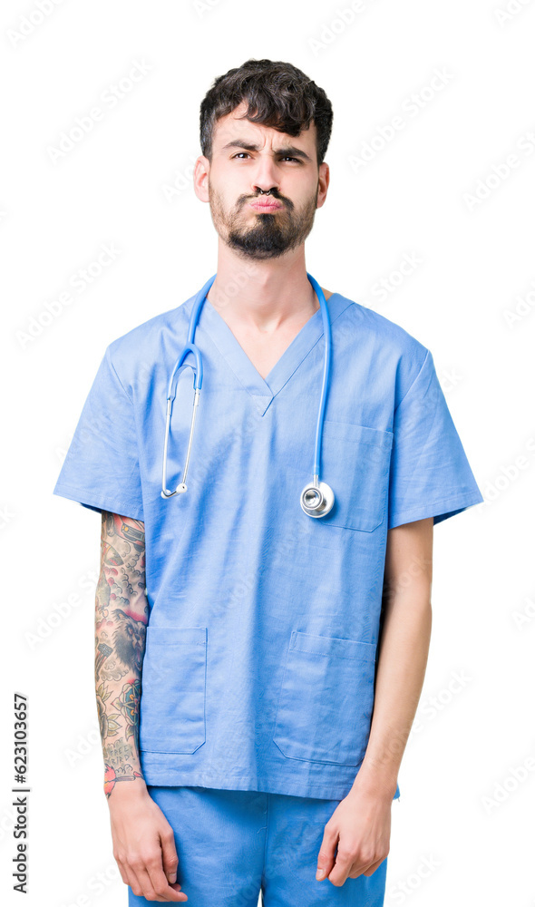Young handsome nurse man wearing surgeon uniform over isolated background puffing cheeks with funny face. Mouth inflated with air, crazy expression. Young handsome nurse man wearing surgeon uniform over isolated background puffing cheeks with funny face. Mouth inflated with air, crazy expression.