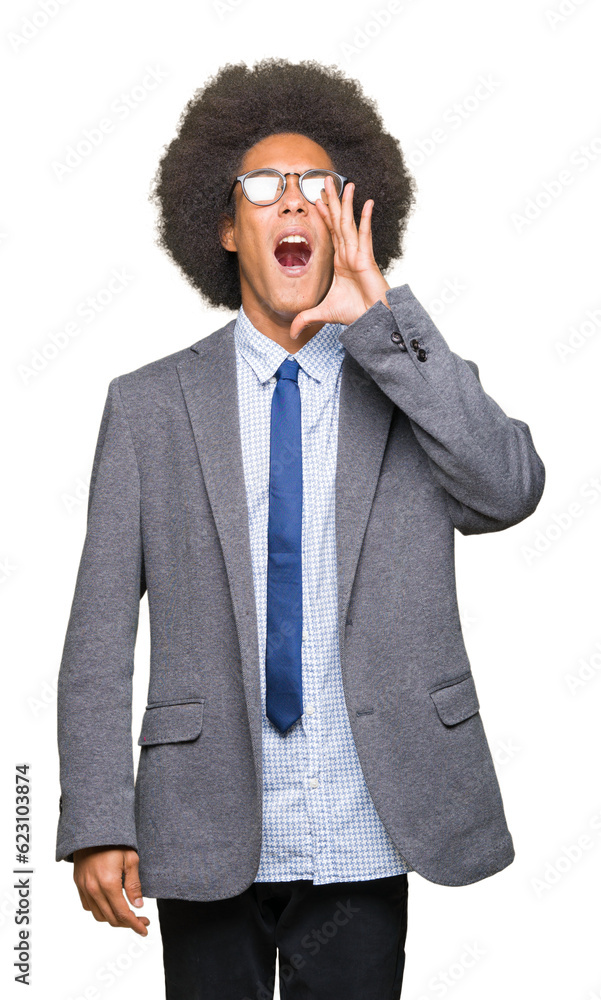 Young african american business man with afro hair wearing glasses shouting and screaming loud to side with hand on mouth. Communication concept. Young african american business man with afro hair wearing glasses shouting and screaming loud to side with hand on mouth. Communication concept.
