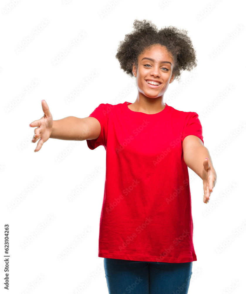 Young afro american woman over isolated background looking at the camera smiling with open arms for hug. Cheerful expression embracing happiness. Young afro american woman over isolated background looking at the camera smiling with open arms for hug. Cheerful expression embracing happiness.