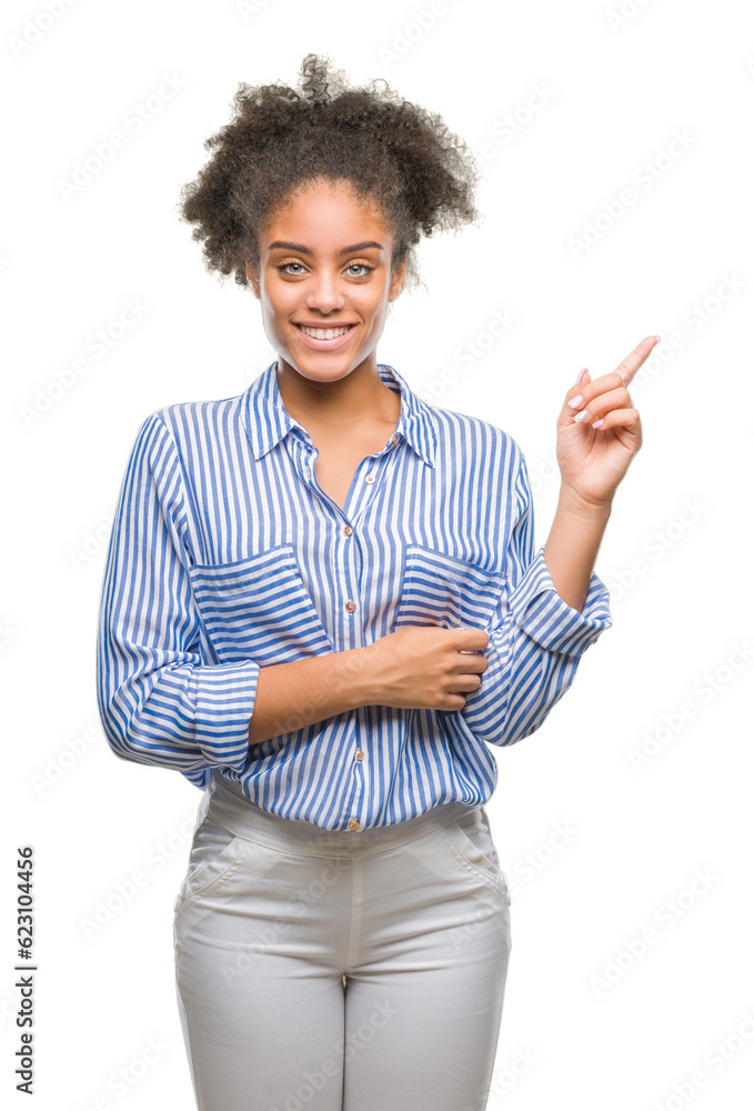 Young afro american woman over isolated background with a big smile on face, pointing with hand and finger to the side looking at the camera.