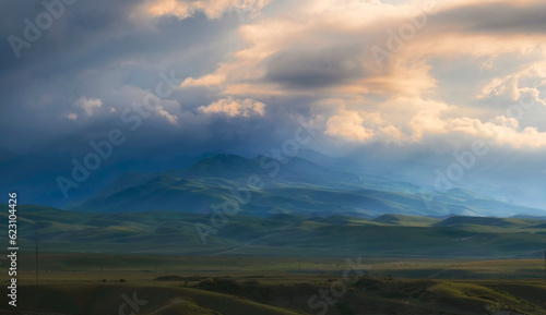 beautiful mountain landscape with clouds at sunset before storm