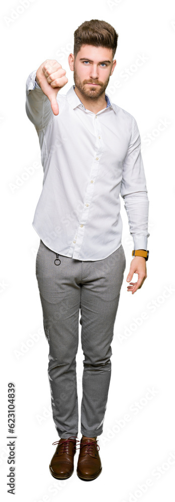 Young handsome business man looking unhappy and angry showing rejection and negative with thumbs down gesture. Bad expression. Young handsome business man looking unhappy and angry showing rejection and negative with thumbs down gesture. Bad expression.