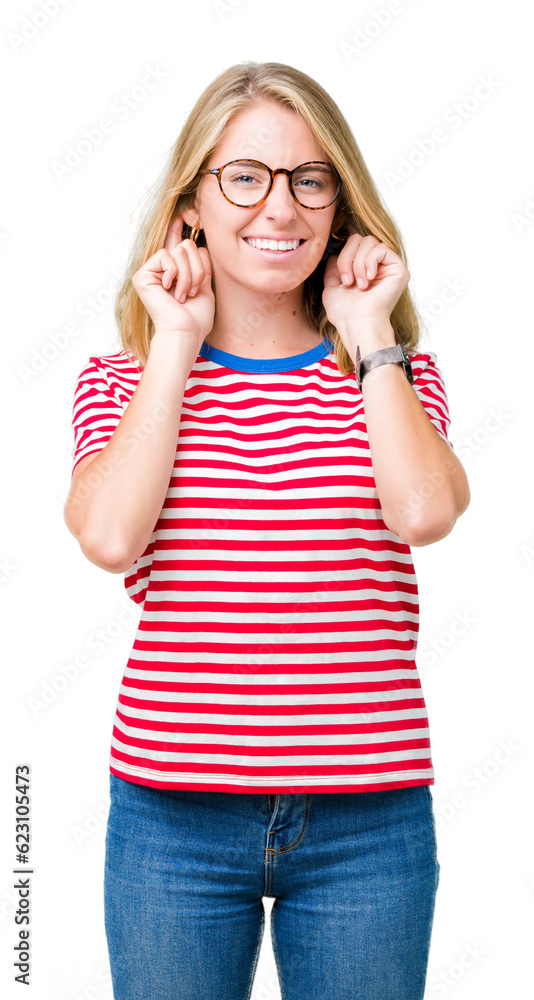 Beautiful young woman wearing glasses over isolated background covering ears with fingers with annoyed expression for the noise of loud music. Deaf concept. Beautiful young woman wearing glasses over isolated background covering ears with fingers with annoyed expression for the noise of loud music. Deaf concept.