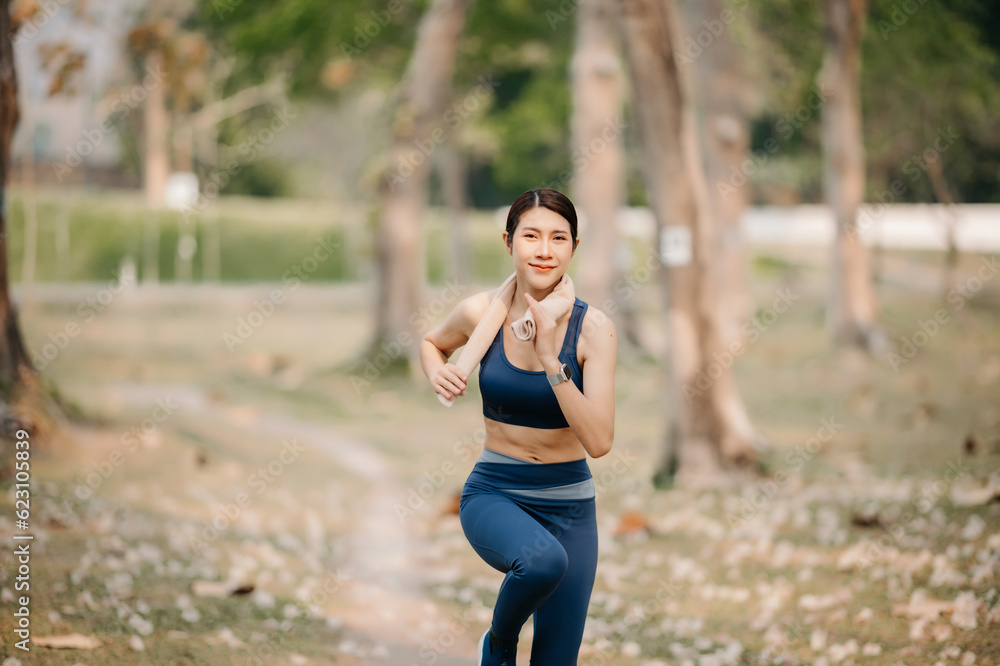 Young sporty woman running in green park.Sport lifestyle. Motion blur. in sun light Young sporty woman running in green park.Sport lifestyle. Motion blur. in sun light