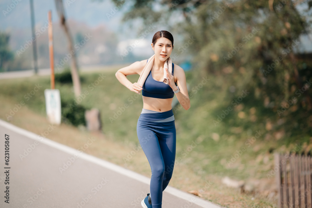 Young sporty woman running in green park.Sport lifestyle. Motion blur. in sun light Young sporty woman running in green park.Sport lifestyle. Motion blur. in sun light