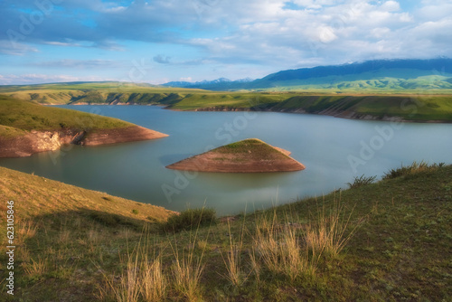 Island in the Bestyubinsk reservoir or Bestobe, a reservoir on the Charyn river in Kazakhstan, a beautiful lake landscape in the mountains