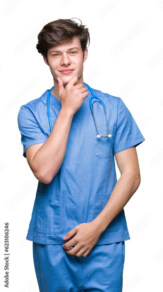 Young doctor wearing medical uniform over isolated background looking confident at the camera with smile with crossed arms and hand raised on chin. Thinking positive. Young doctor wearing medical uniform over isolated background looking confident at the camera with smile with crossed arms and hand raised on chin. Thinking positive.