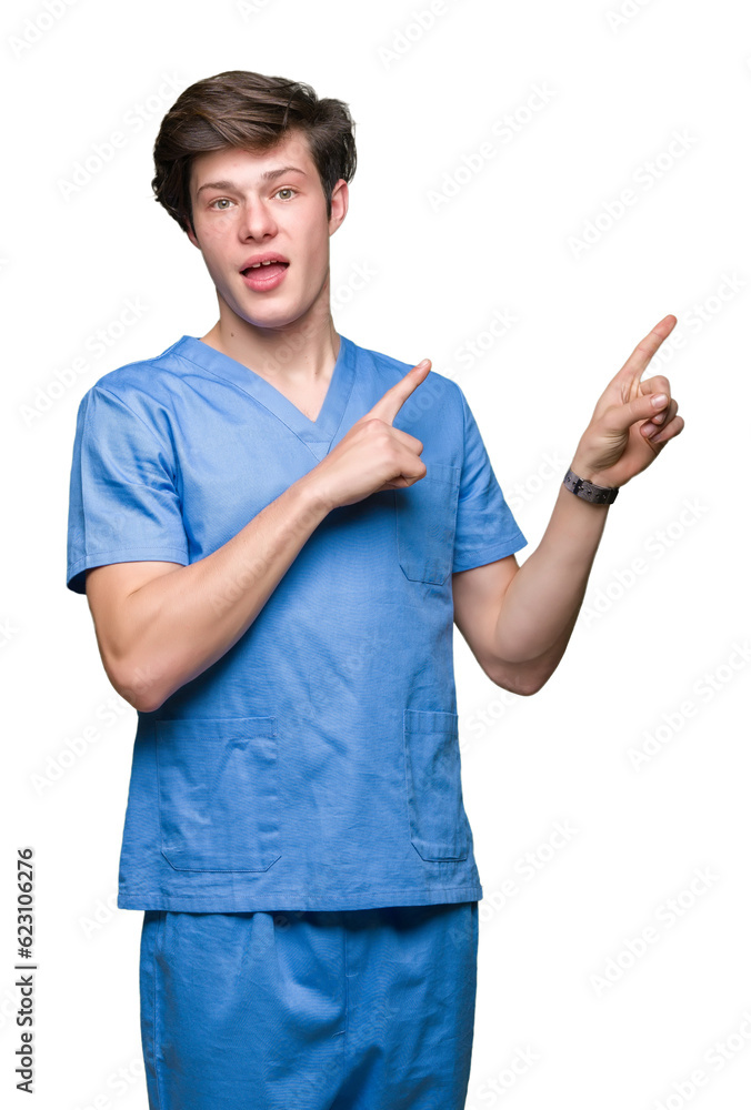 Young doctor wearing medical uniform over isolated background smiling and looking at the camera pointing with two hands and fingers to the side.