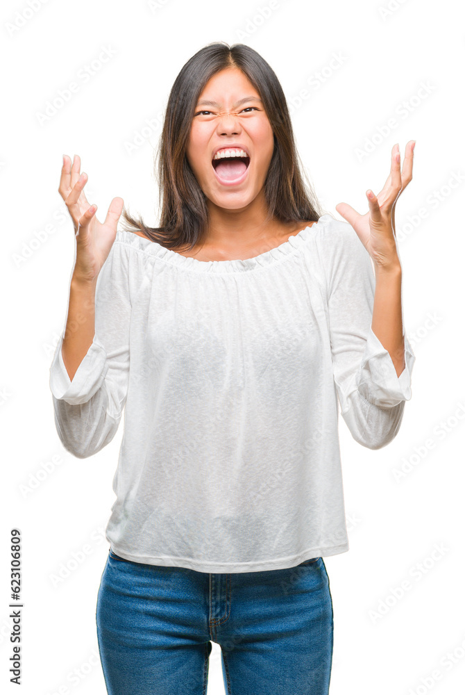 Young asian woman over isolated background crazy and mad shouting and yelling with aggressive expression and arms raised. Frustration concept. Young asian woman over isolated background crazy and mad shouting and yelling with aggressive expression and arms raised. Frustration concept.
