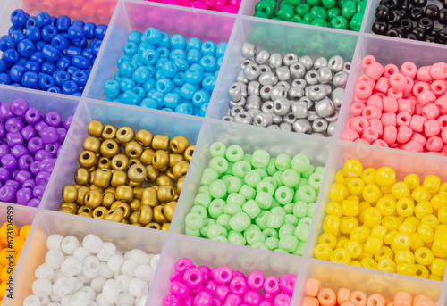 Multi-colored beads in separate cells of a plastic container