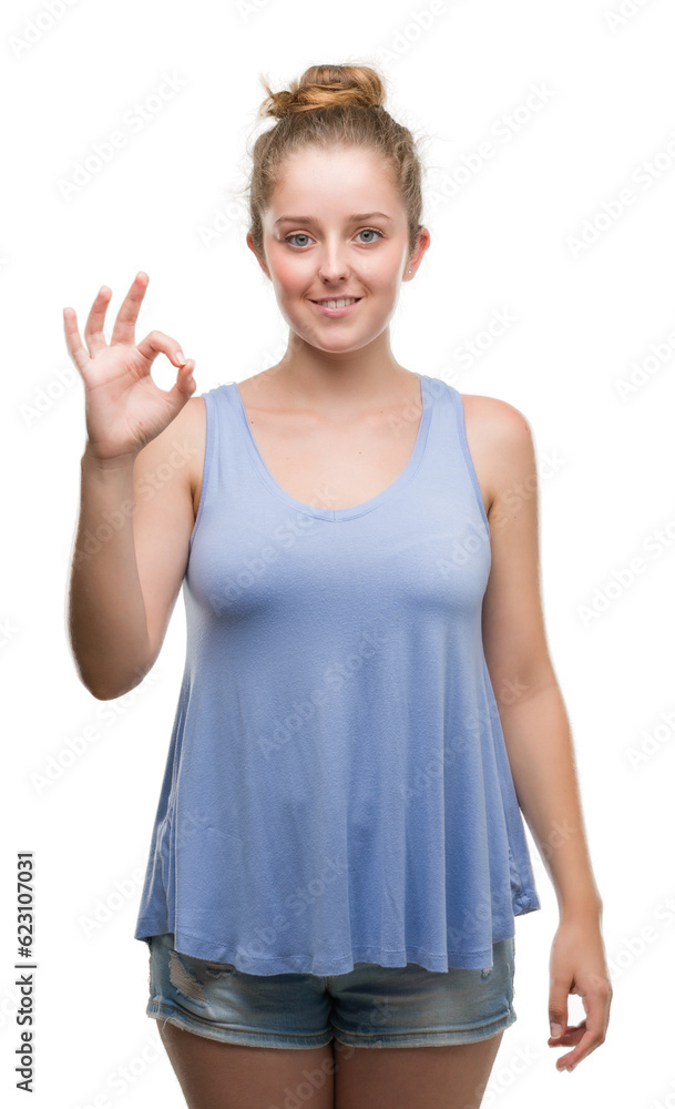 Young blonde woman smiling positive doing ok sign with hand and fingers. Successful expression. Young blonde woman smiling positive doing ok sign with hand and fingers. Successful expression.